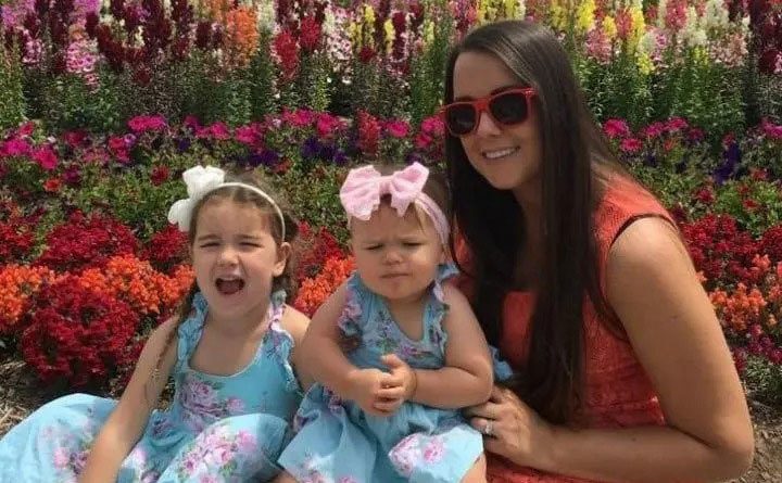 Natasha poses with her two daughters.
