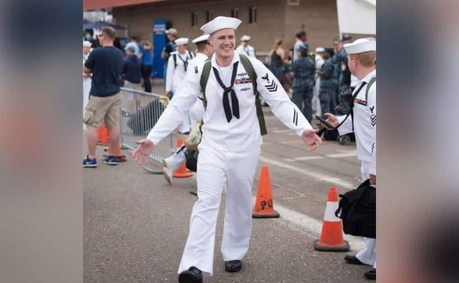 Chris aproches his family after disembarking his ship.