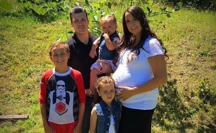 Chris and his family pose together.