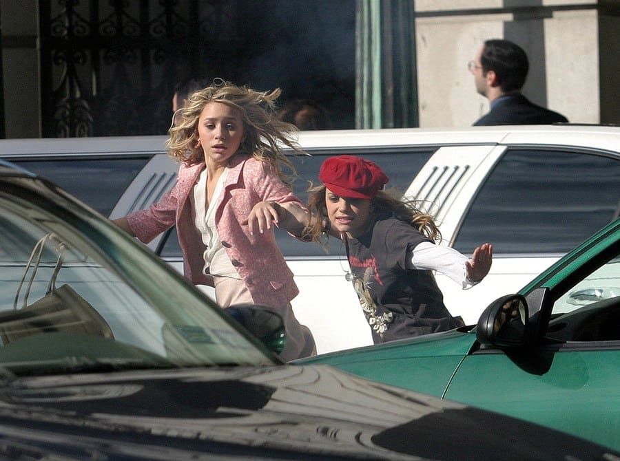 Mary-Kate and Ashley Olsen were running across the street, stopping traffic in a scene from New York Minute.