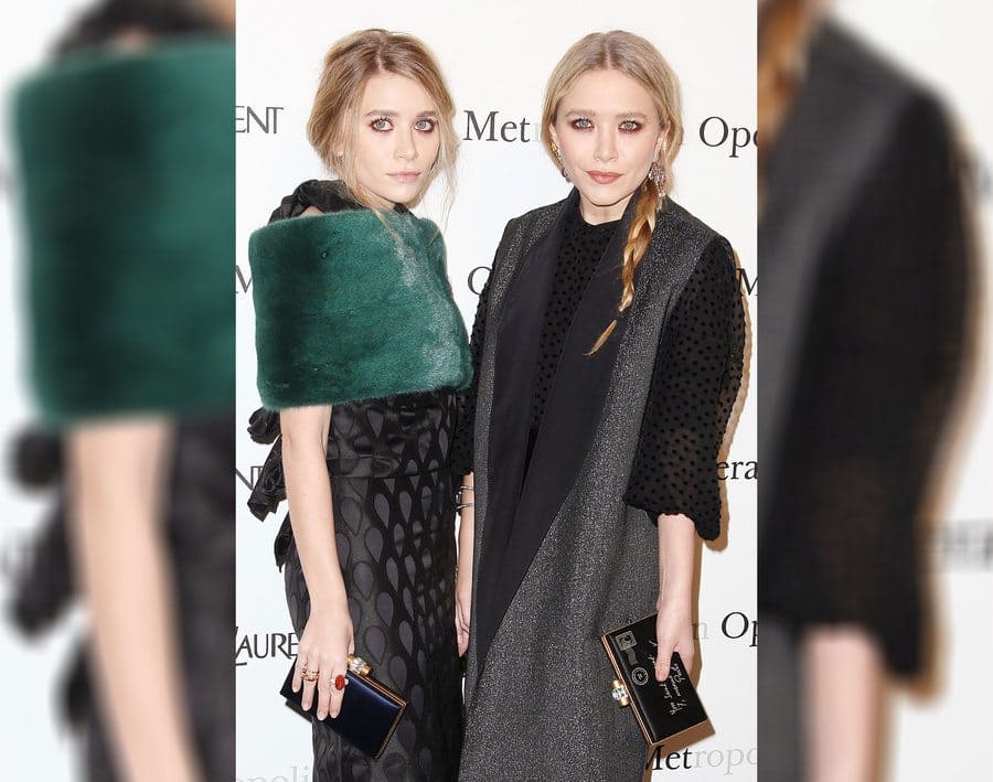 Mary-Kate and Ashley Olsen are wearing fur and holding leather clutches.