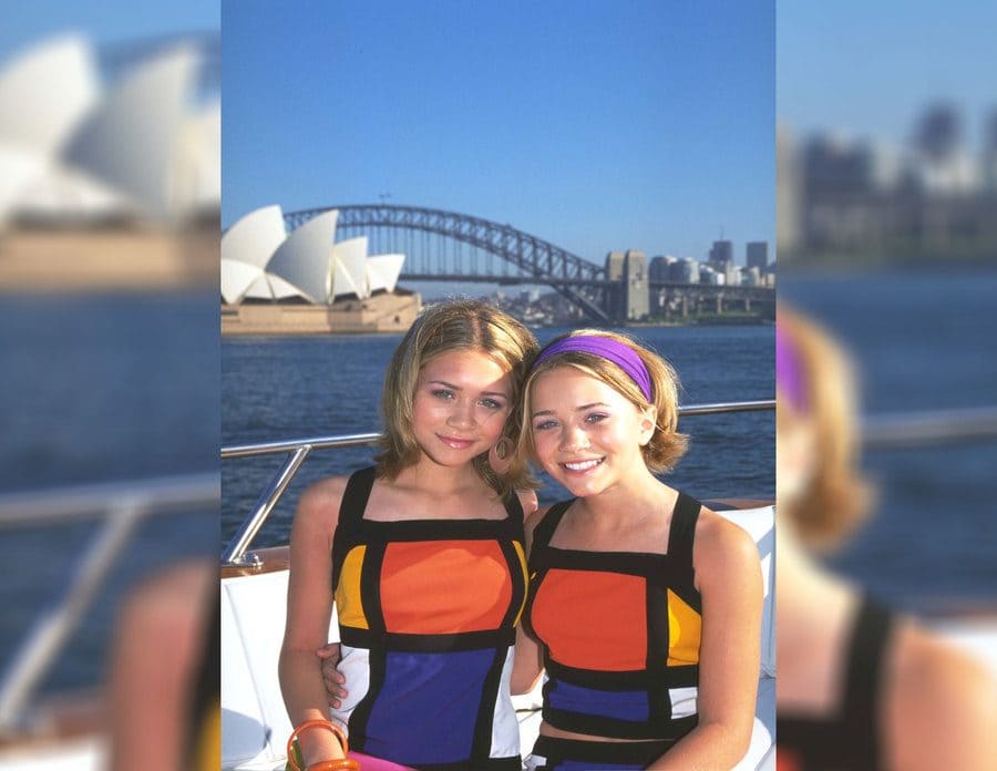 Mary-Kate and Ashley on a boat in Australia in front of the opera house while filming Our Lips Are Sealed in 2000.